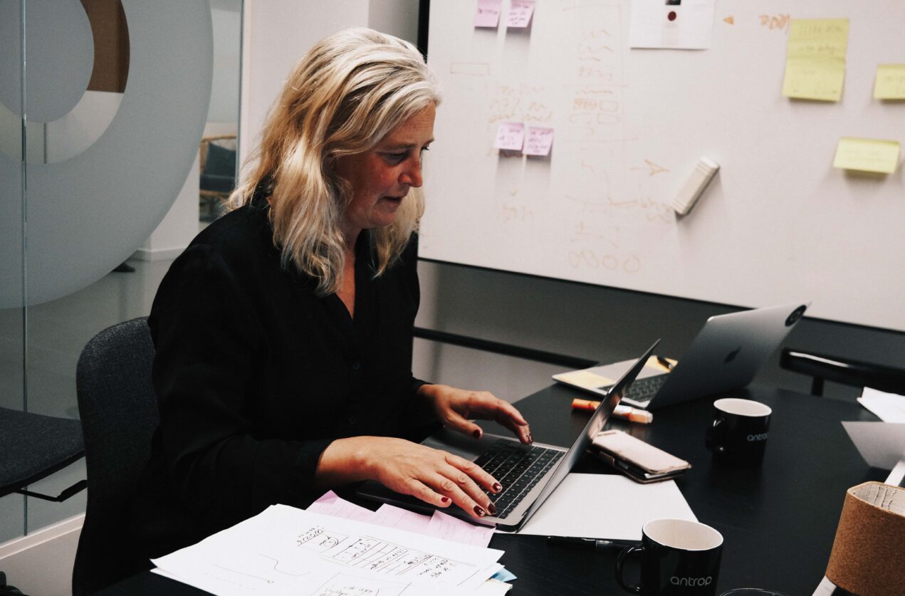 En kvinna sitter och gör research på en dator.